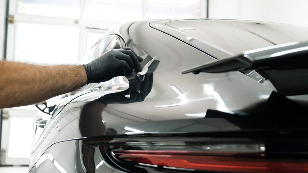 A black supercar being polished