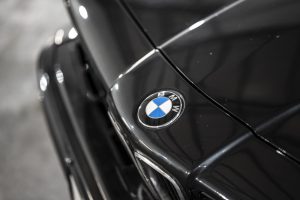 Close-up of the BMW badge on a black vintage bonnet