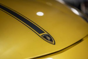 The yellow bonnet of a Lamborghini, with badge