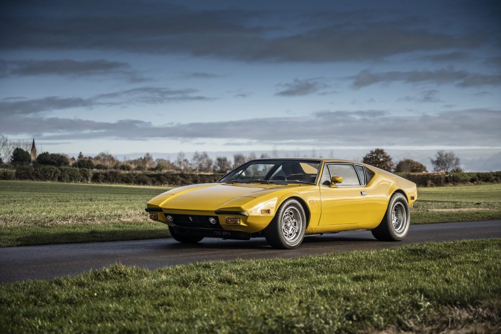 Classic yellow supercar stationary on a racetrack